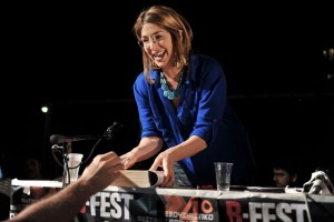 Canadian author and social activist Naomi Klein signs a copy of her book after addressing the Athens anti-authoriterian festival late on May 25, 2013. The fourth edition of international anti-authoritarian festival B-Fest takes place at Panepistimioupoli, the Athens University Campus. Klein has attracted a considerable following in Greece, where the Greek translation of her book The Shock Doctrine was in the bestsellers list for months. AFP PHOTO/ LOUISA GOULIAMAKI